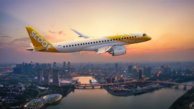 This picture shows the Embraer E2 in Scoot colors above Singapore.